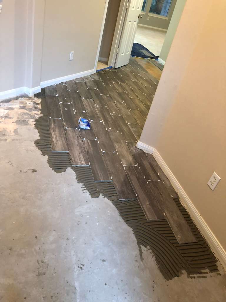Wood-look tile flooring installation in progress